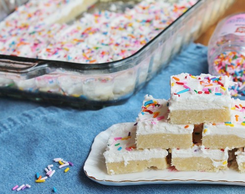 Perfect Sugar Cookie Bars: soft, chewy, a healthy layer of vanilla icing...these are one of the most popular treats I bake!